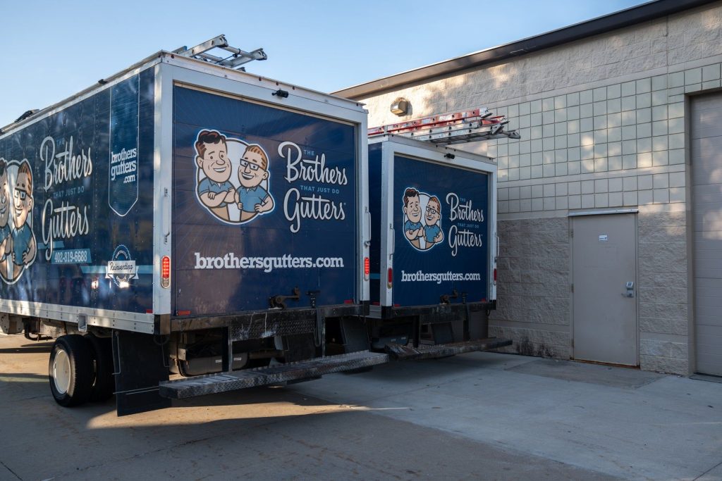Two Brothers Gutters box trucks parked at the shop