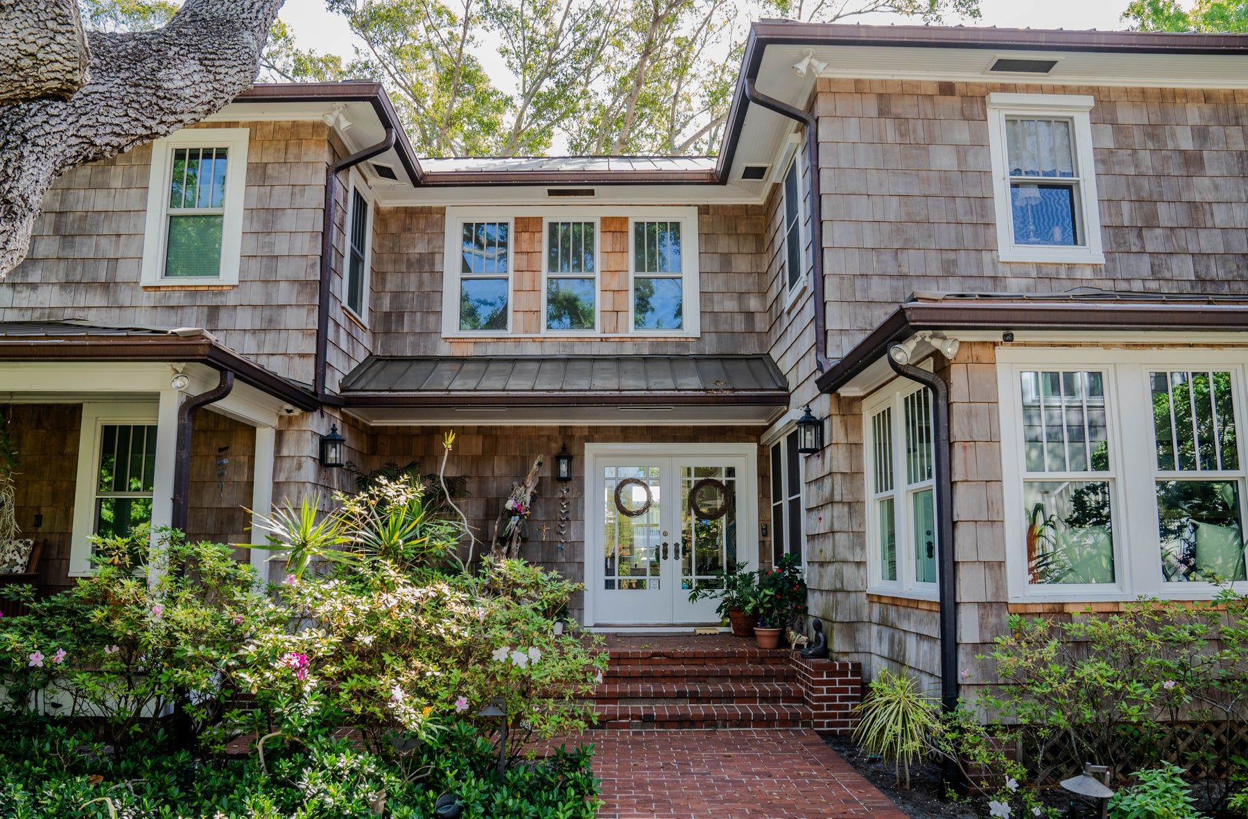 Copper gutters and downspouts at a front entry