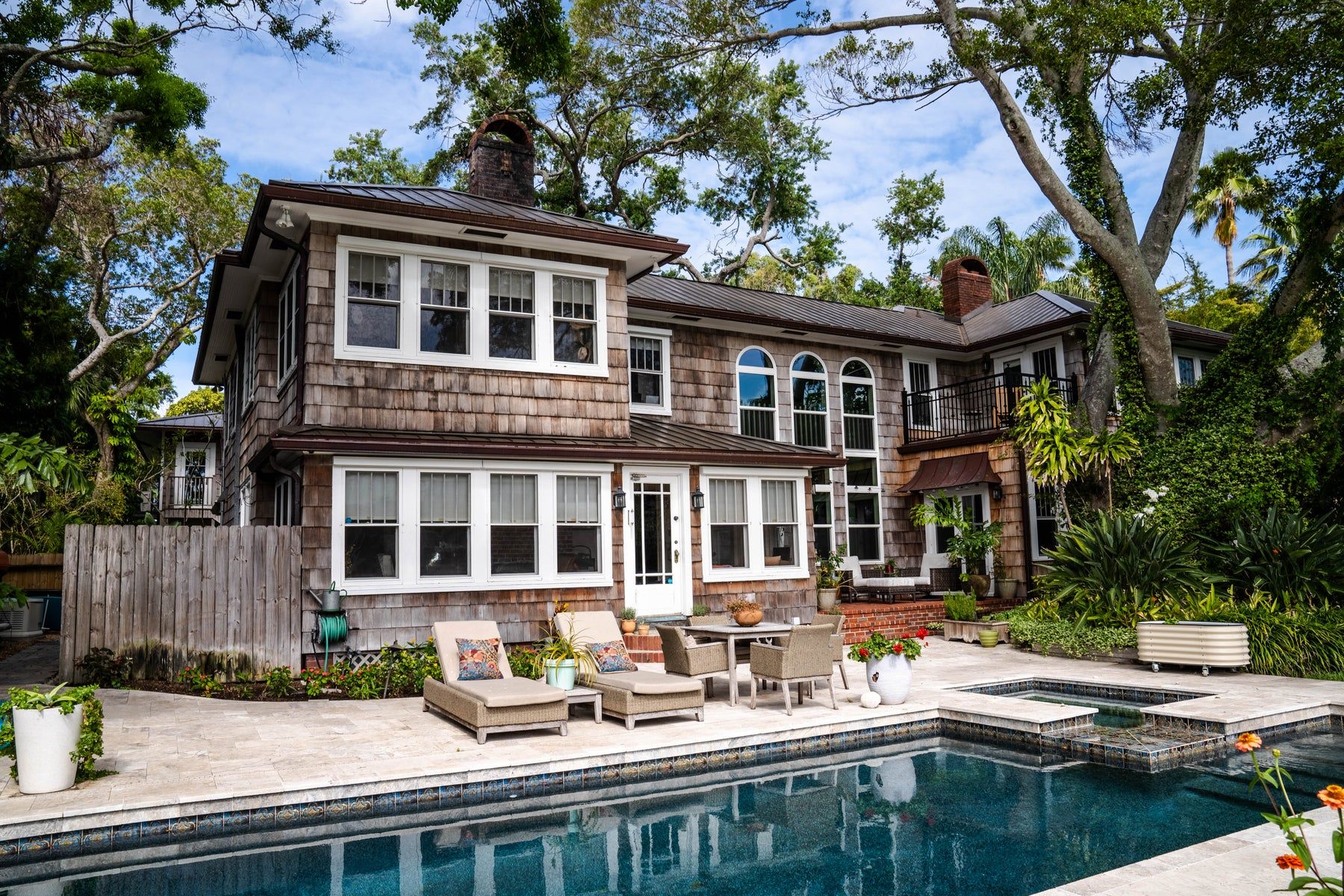 Copper K-style gutters on a shingle home with a pool