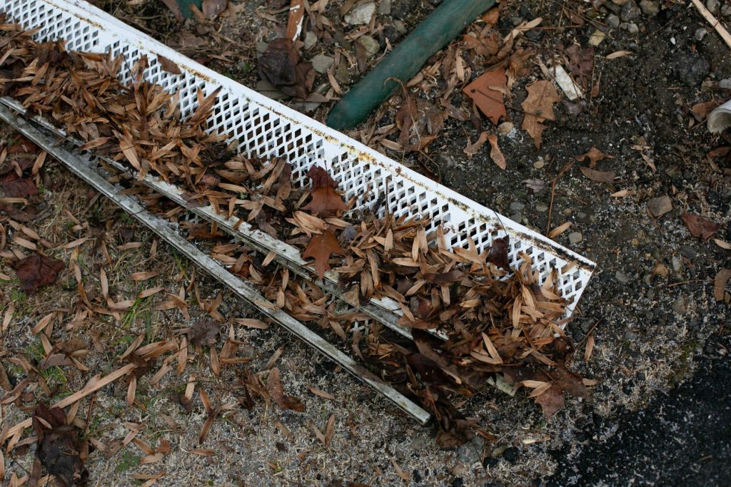 Old plastic leaf guards pulled off and full of debris
